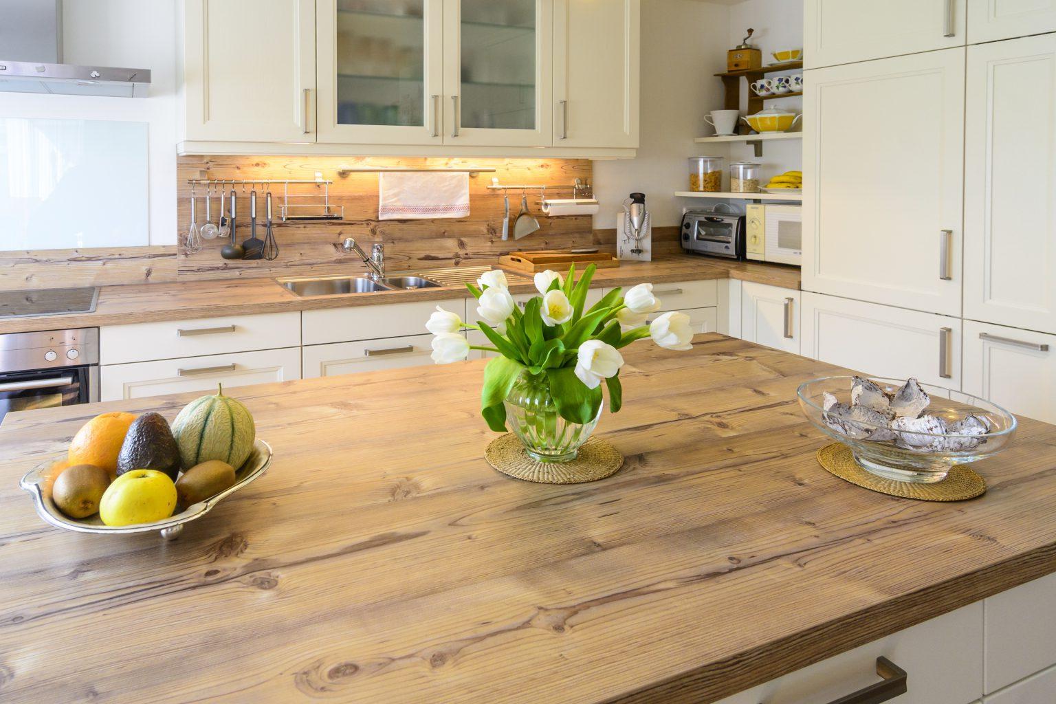 overview of a kitchen with plants and fruit bowl on the counter